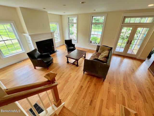 121 E Dugway Rd, Lenox, MA 01240 - living area with light wood-style flooring, a fireplace with flush hearth, french doors, and recessed lighting