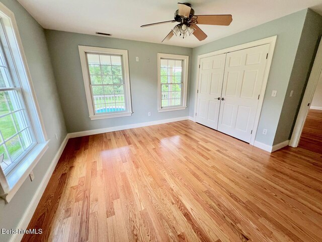121 E Dugway Rd, Lenox, MA 01240 - unfurnished bedroom with light wood-style floors, a closet, and a ceiling fan
