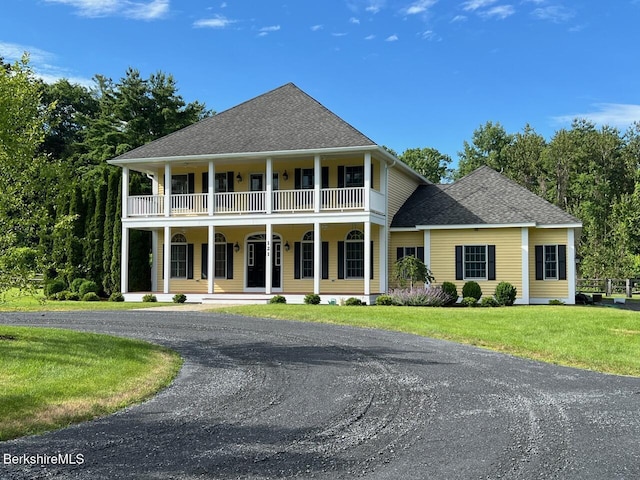 121 E Dugway Rd, Lenox, MA 01240 - greek revival house with a balcony, a porch, a front yard, and roof with shingles