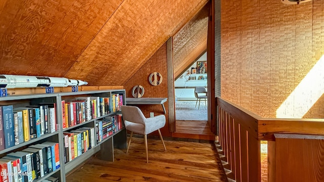 living area with wood-type flooring and vaulted ceiling