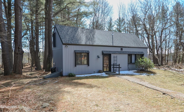 view of front facade with roof with shingles