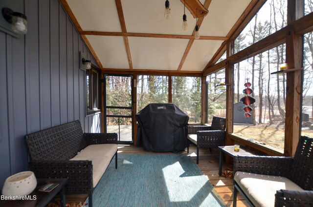 sunroom / solarium featuring vaulted ceiling