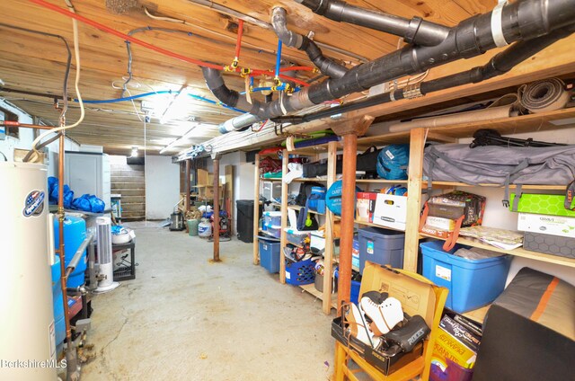 unfinished basement featuring water heater