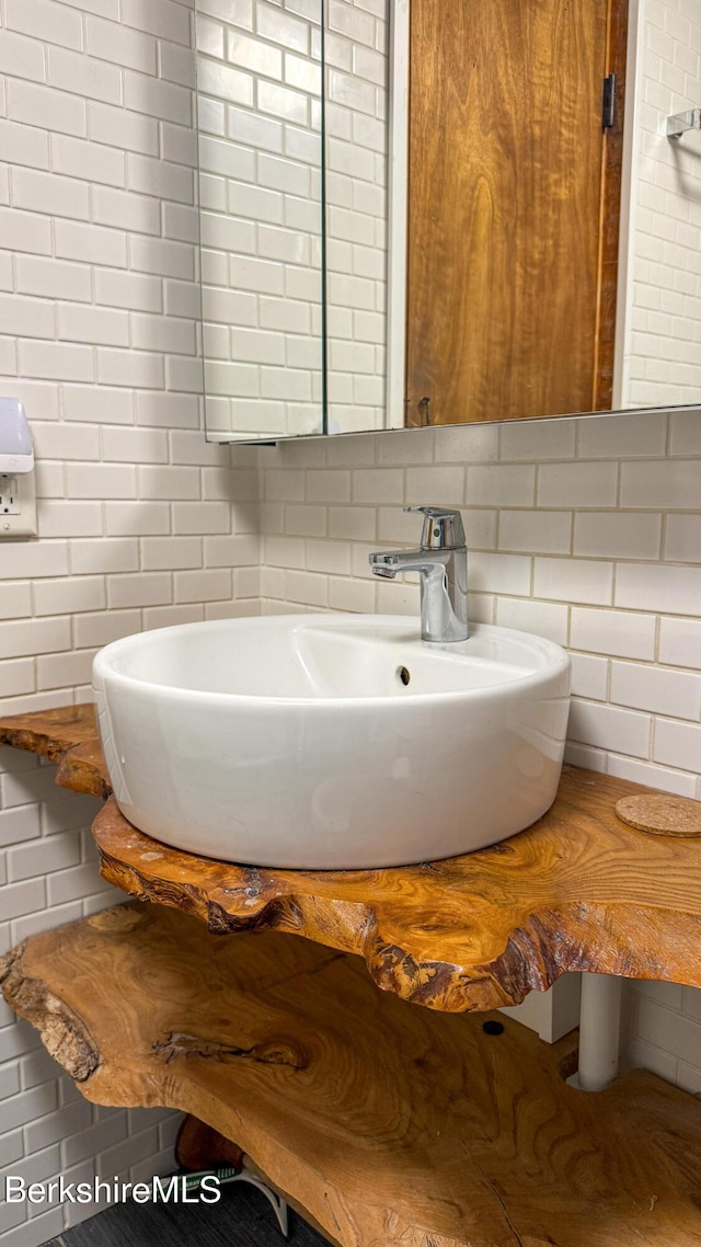 bathroom featuring decorative backsplash and a sink