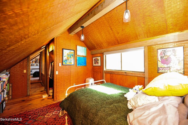 bedroom featuring vaulted ceiling with beams