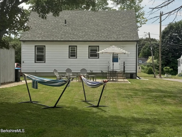 17 Crane Ave, Pittsfield, MA 01201 - back of property with a shingled roof, a yard, and a patio area