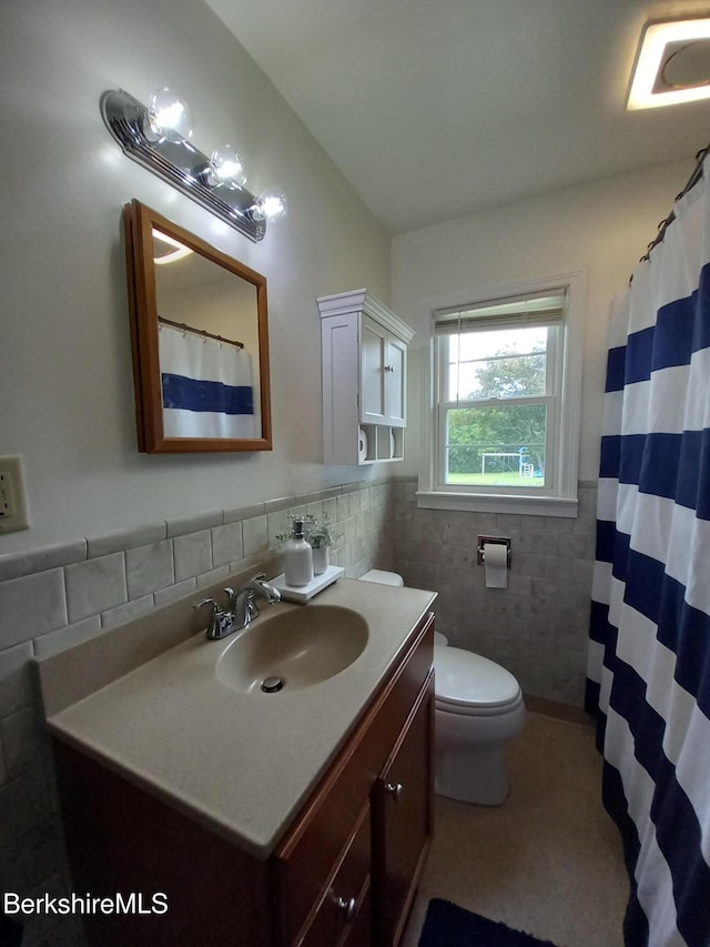 17 Crane Ave, Pittsfield, MA 01201 - bathroom with tile walls, vanity, and a wainscoted wall