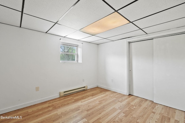 1310 Lenox Rd, Richmond, MA 01254 - below grade area with baseboard heating, wood finished floors, and a drop ceiling