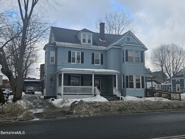 view of front of house with a porch and a chimney