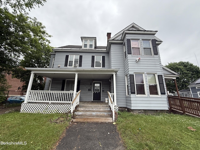 153 First St, Pittsfield, MA 01201 - view of front facade with a porch, a front lawn, and a chimney
