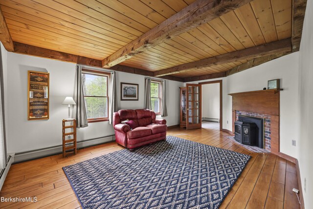 64 Blotz Rd, Washington, MA 01223 - living room with a wood stove, wood-type flooring, baseboard heating, wooden ceiling with exposed beams, and french doors