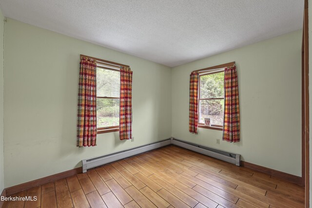 64 Blotz Rd, Washington, MA 01223 - spare room with wood finished floors, a textured ceiling, baseboards, and baseboard heating