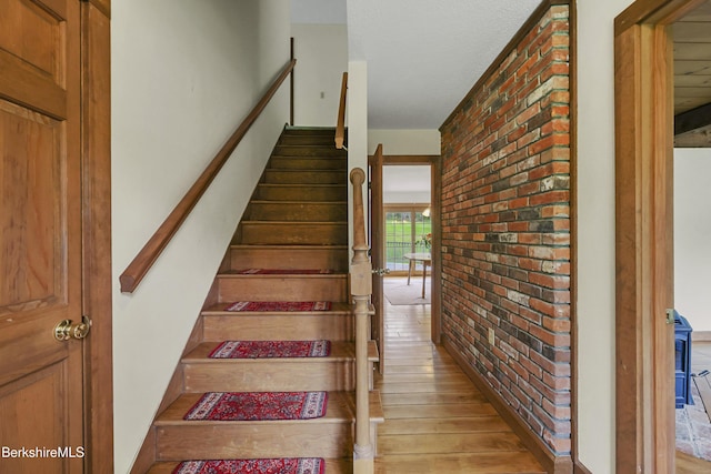 64 Blotz Rd, Washington, MA 01223 - stairway with wood finished floors and brick wall