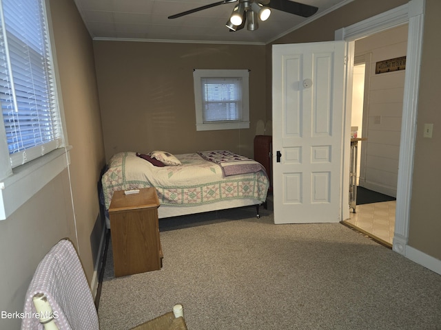 carpeted bedroom with ceiling fan and ornamental molding