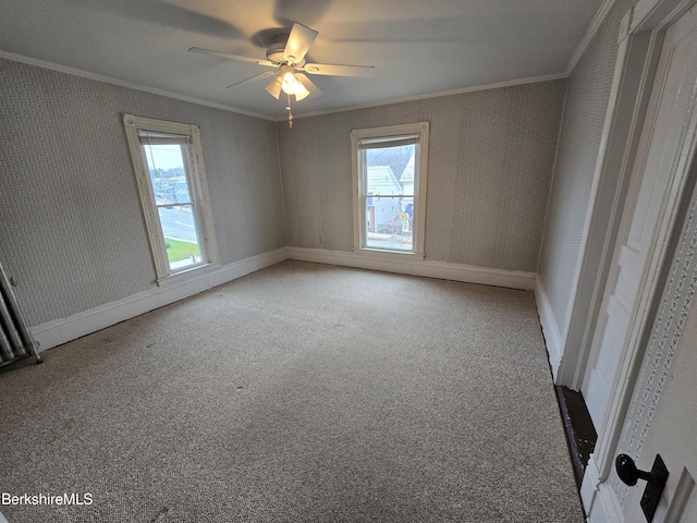 spare room with carpet, ceiling fan, and crown molding