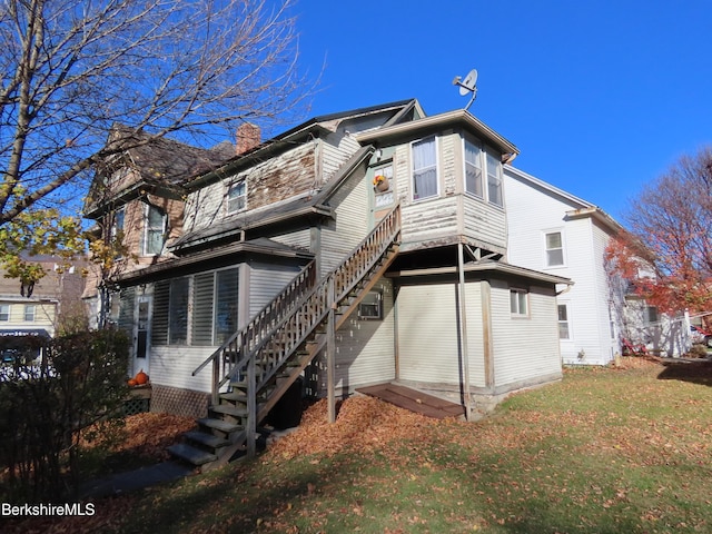 rear view of property with a yard