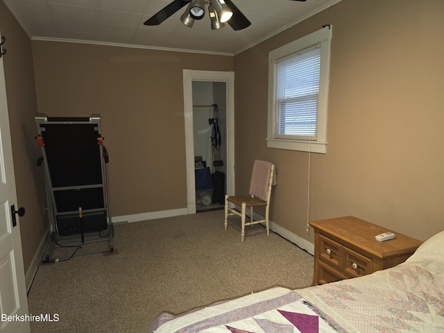 carpeted bedroom featuring ceiling fan and ornamental molding