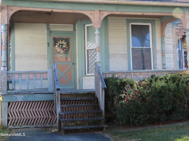 view of exterior entry with covered porch