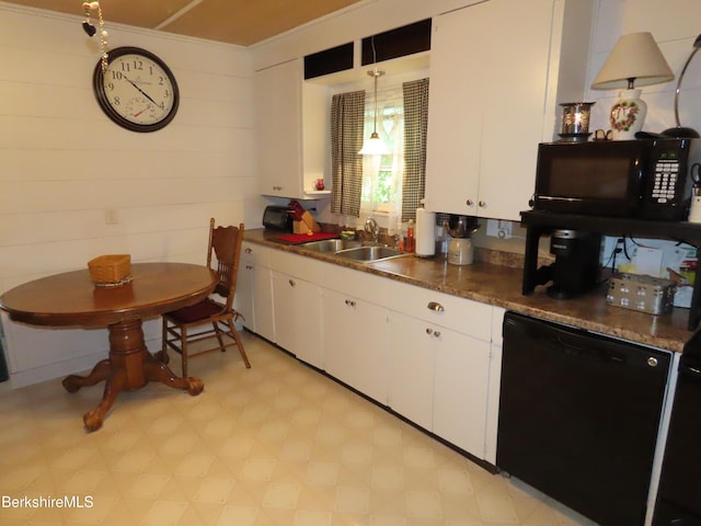 kitchen featuring pendant lighting, sink, white cabinetry, and black appliances