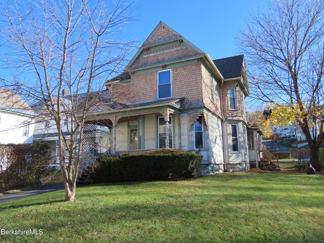 victorian-style house featuring a front lawn