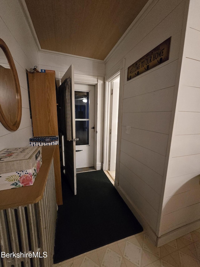 corridor with wood walls and wooden ceiling