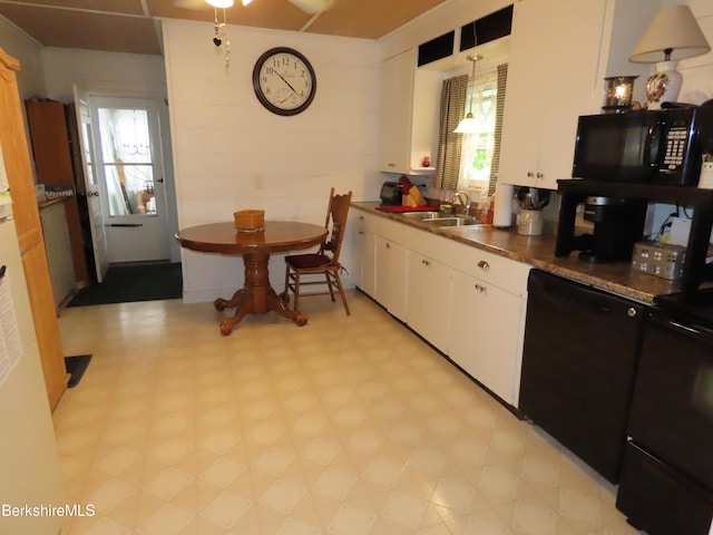 kitchen with white cabinets, black appliances, sink, hanging light fixtures, and a healthy amount of sunlight