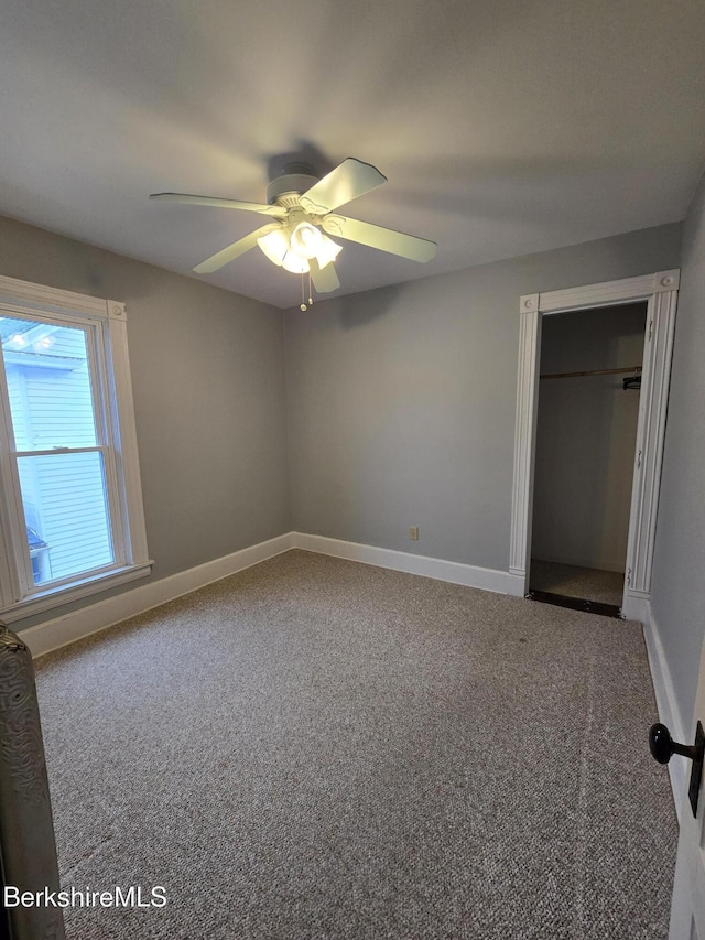 unfurnished bedroom with ceiling fan, a closet, and carpet