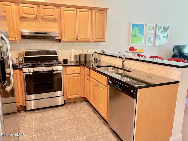 2 Evergreen Trl Unit 2, Lenox, MA 01240 - kitchen with stainless steel appliances, a sink, a peninsula, exhaust hood, and tasteful backsplash