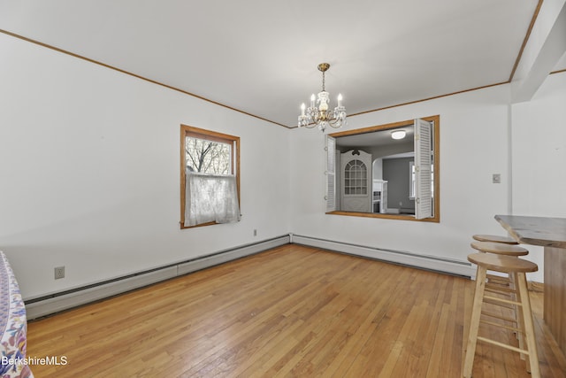 unfurnished dining area with a baseboard heating unit, a notable chandelier, and hardwood / wood-style flooring