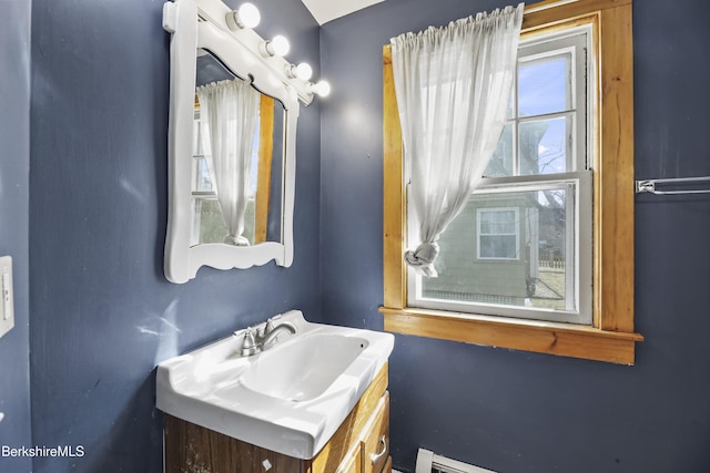 bathroom with vanity and baseboard heating