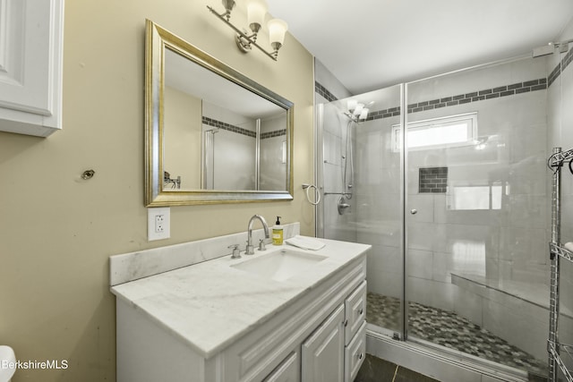 full bathroom featuring a shower stall and vanity