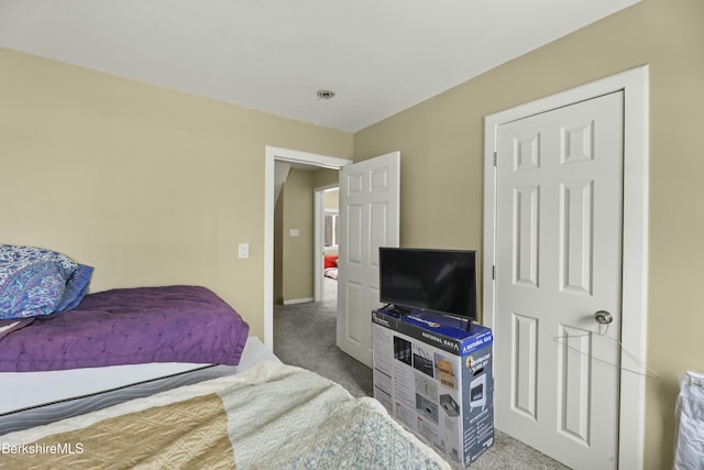 bedroom featuring light carpet and baseboards