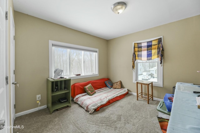 bedroom featuring carpet and baseboards