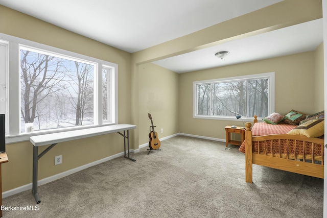 bedroom featuring light carpet and baseboards