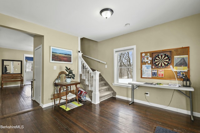 stairs featuring wood finished floors and baseboards