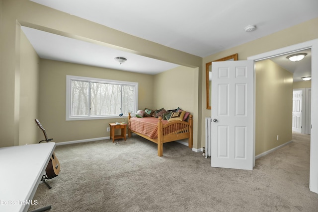 bedroom with light carpet and baseboards