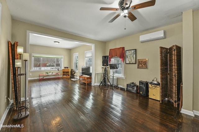 unfurnished living room featuring ceiling fan, a wall unit AC, dark wood-type flooring, baseboards, and radiator heating unit