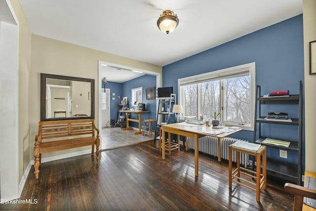 office area featuring radiator heating unit, wood finished floors, and baseboards