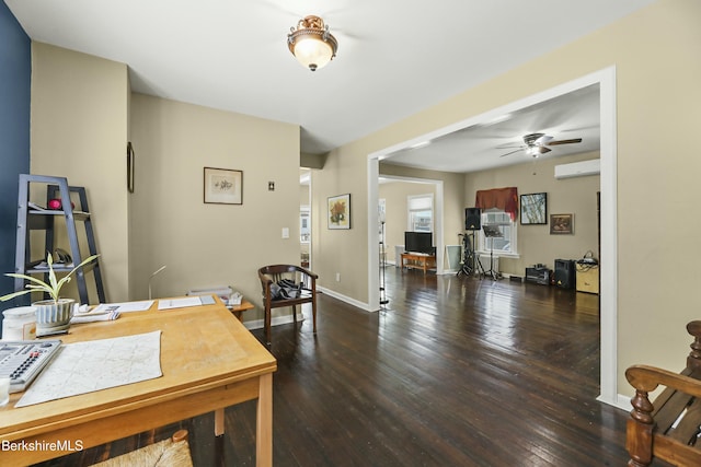 dining room with ceiling fan, baseboards, wood finished floors, and an AC wall unit