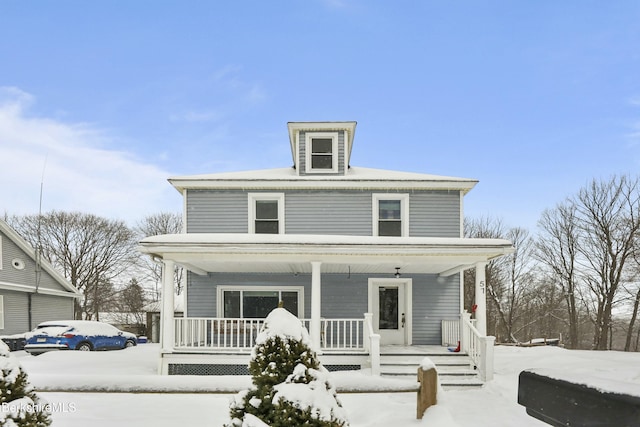 american foursquare style home featuring a porch