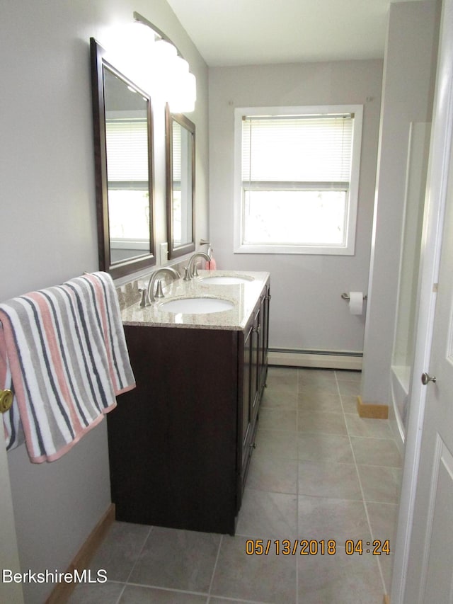 bathroom with tile patterned flooring, plenty of natural light, vanity, and a baseboard radiator