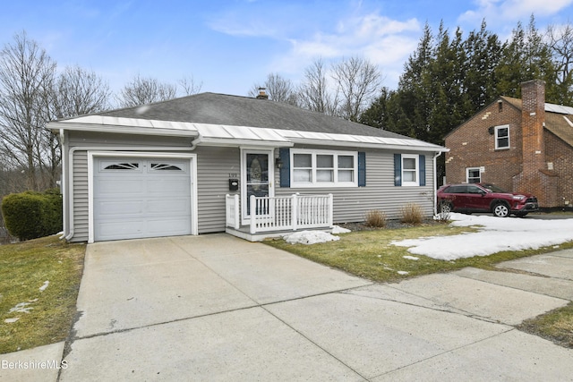 ranch-style house with a porch, driveway, roof with shingles, and an attached garage