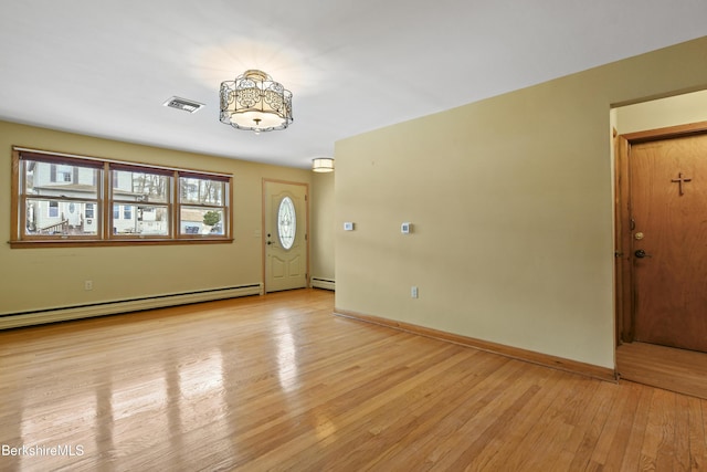 foyer with light wood-type flooring, visible vents, a baseboard heating unit, a baseboard radiator, and baseboards