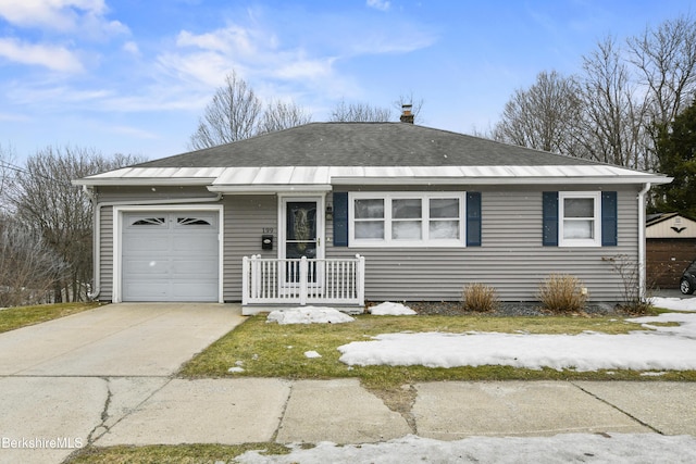 ranch-style home with concrete driveway, an attached garage, and roof with shingles