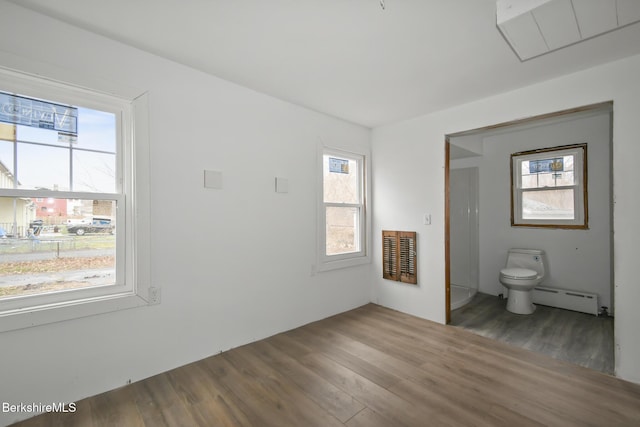 111 Columbia St, Adams, MA 01220 - interior space with wood finished floors, a baseboard heating unit, and heating unit