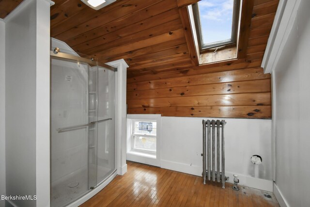 111 Columbia St, Adams, MA 01220 - bathroom featuring vaulted ceiling with skylight, wood-type flooring, wooden ceiling, a stall shower, and baseboards