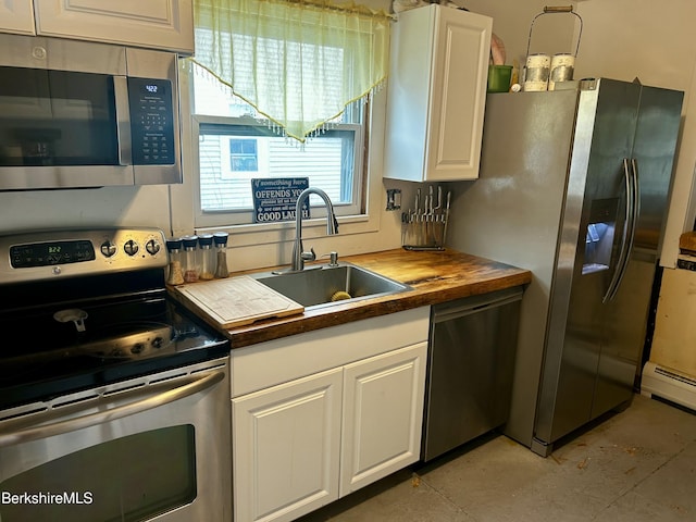 89-91 N Summer St, Adams, MA 01220 - kitchen featuring stainless steel appliances, wood counters, white cabinetry, and a baseboard heating unit