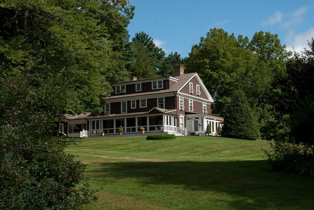 221 Bulkley St, Williamstown, MA 01267 - rear view of house featuring a sunroom, a chimney, and a yard