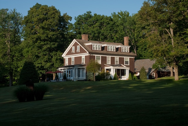 221 Bulkley St, Williamstown, MA 01267 - view of front of home featuring a chimney, a front yard, and a sunroom
