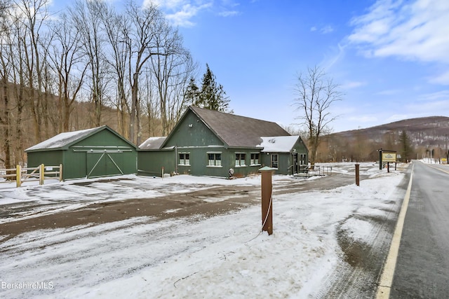 exterior space featuring a garage and an outbuilding